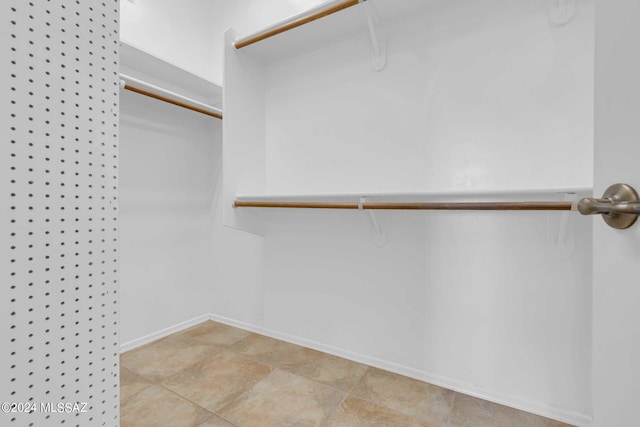 walk in closet featuring light tile patterned floors