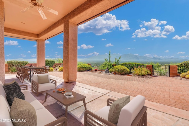 view of patio / terrace featuring ceiling fan, a mountain view, and outdoor lounge area