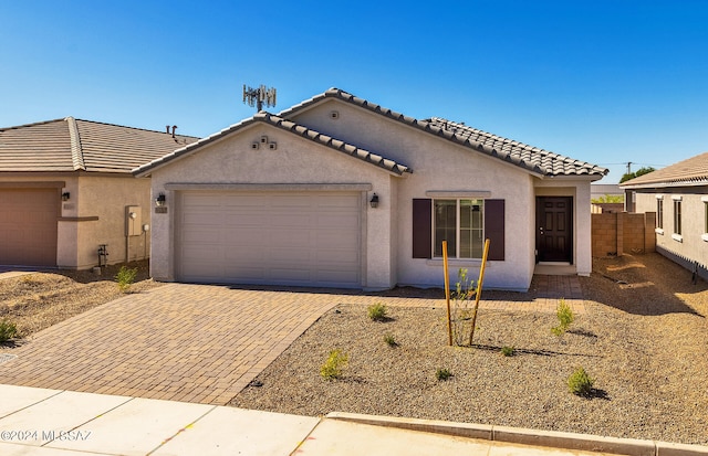 mediterranean / spanish-style house with a garage