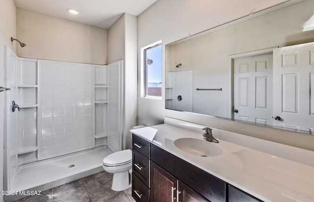 bathroom with a shower, vanity, toilet, and tile patterned flooring