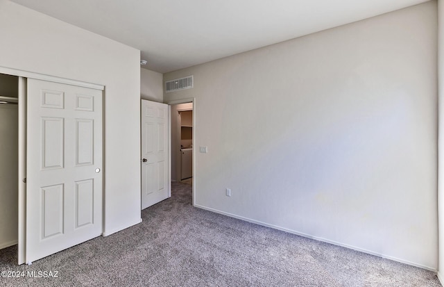 unfurnished bedroom with a closet and carpet