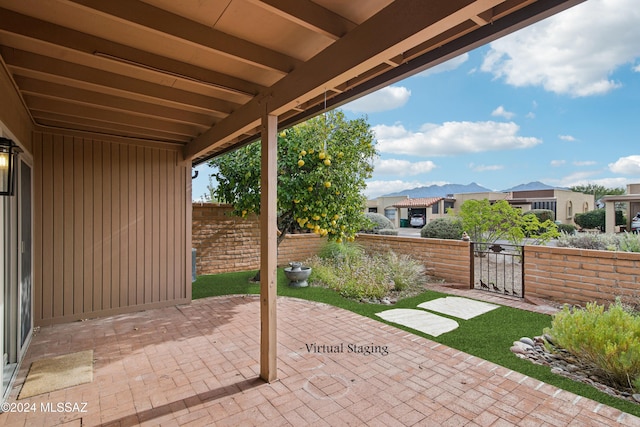 view of patio featuring a gate, a residential view, and fence