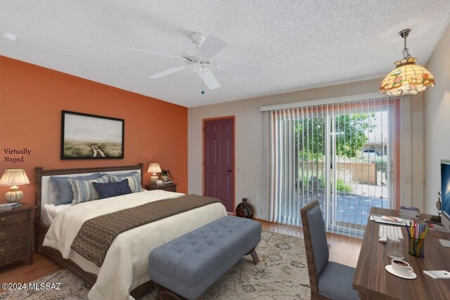 unfurnished room featuring ceiling fan, a textured ceiling, and light hardwood / wood-style flooring