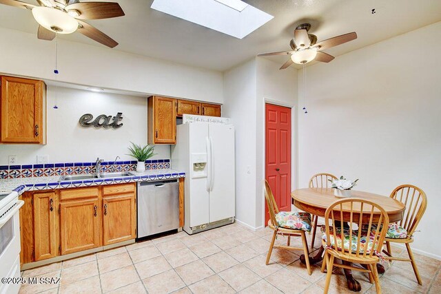 kitchen with ceiling fan, light hardwood / wood-style floors, and a textured ceiling