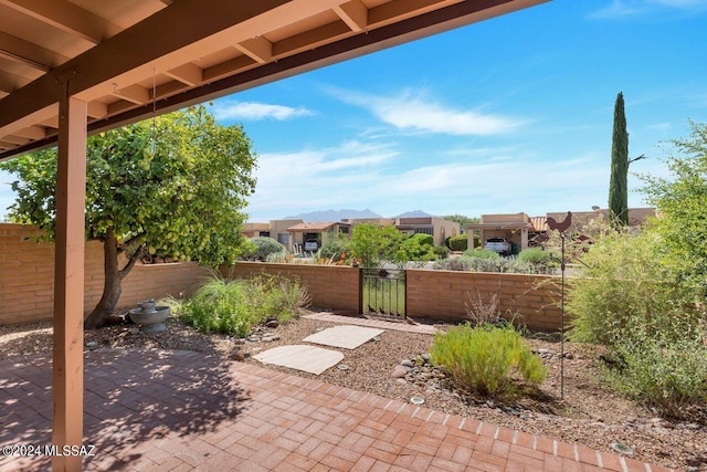 view of patio with a fenced front yard and a gate