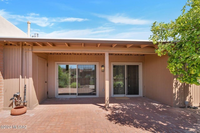 entrance to property featuring a patio area