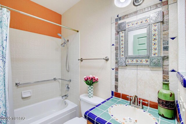 bathroom featuring vanity, toilet, and shower / bath combo with shower curtain