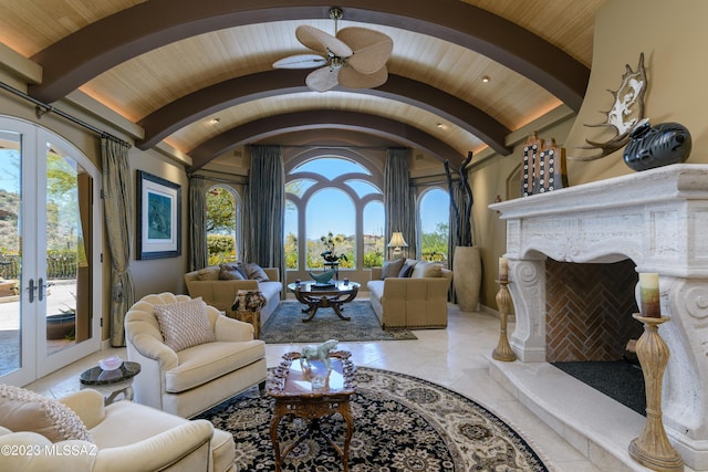 living room with french doors, brick ceiling, ceiling fan, lofted ceiling with beams, and a premium fireplace