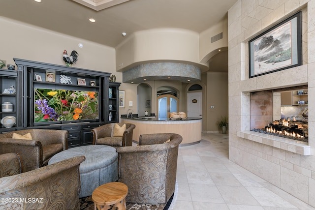 interior space featuring a fireplace and a high ceiling