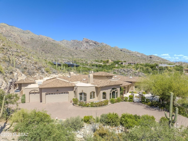 view of front facade featuring a mountain view and a garage