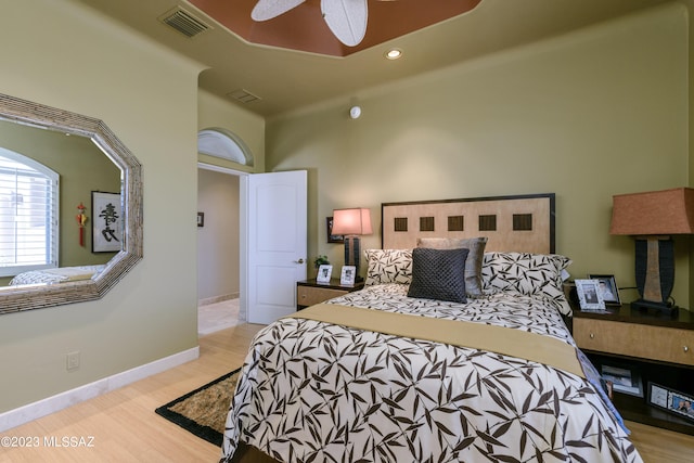 bedroom with light hardwood / wood-style floors and ceiling fan