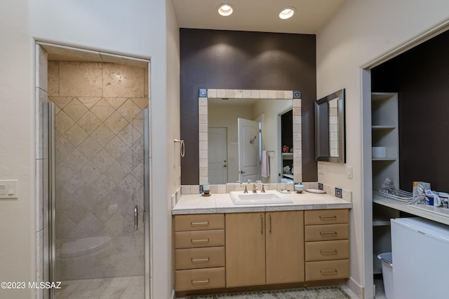 bathroom featuring vanity, built in features, and an enclosed shower