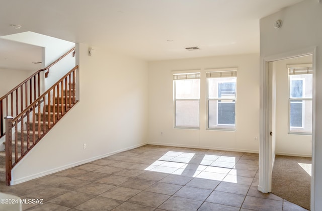 spare room featuring light tile patterned floors