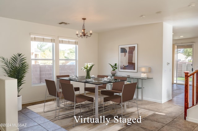 dining room with light tile patterned flooring and a chandelier