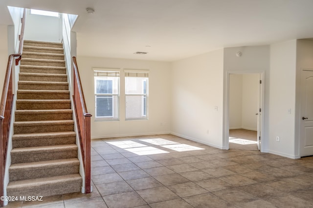 unfurnished room with light tile patterned floors