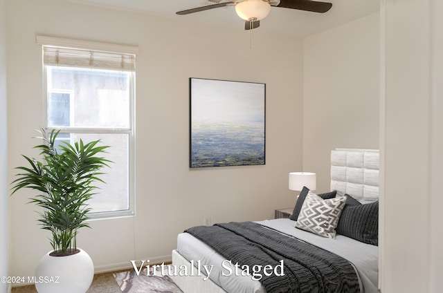 bedroom featuring multiple windows and ceiling fan