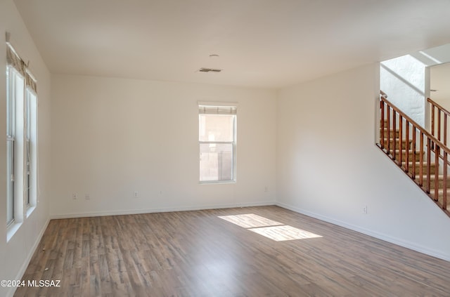 spare room featuring wood-type flooring