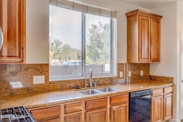 kitchen with black dishwasher, backsplash, stainless steel range oven, and sink