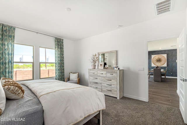 bedroom featuring visible vents, baseboards, and carpet