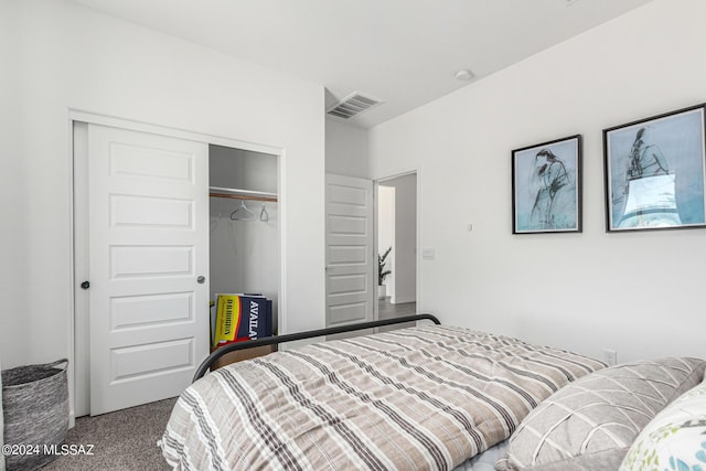 bedroom featuring a closet, visible vents, and carpet