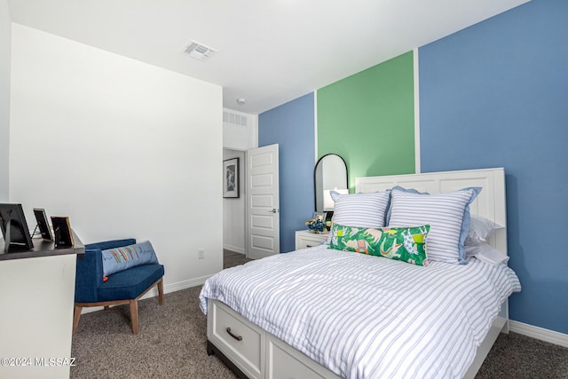 carpeted bedroom featuring baseboards and visible vents