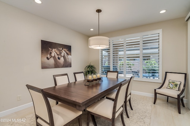 dining space with light hardwood / wood-style floors