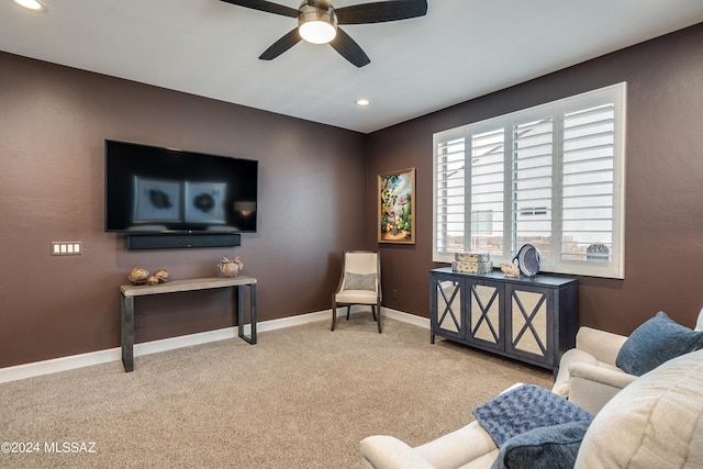 sitting room featuring ceiling fan and light colored carpet