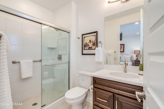 bathroom with tile patterned flooring, vanity, toilet, and an enclosed shower