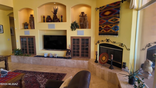 living room featuring a tiled fireplace