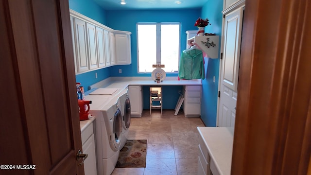 laundry area with cabinets, light tile patterned floors, and washing machine and clothes dryer