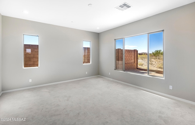 empty room featuring light carpet