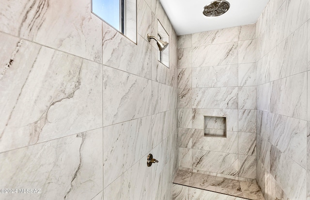 bathroom with tiled shower