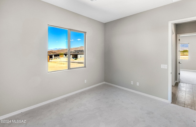 carpeted empty room featuring plenty of natural light