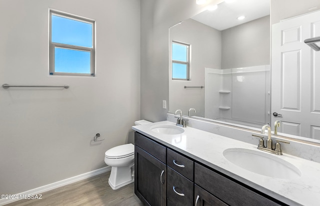 bathroom featuring wood-type flooring, vanity, and toilet