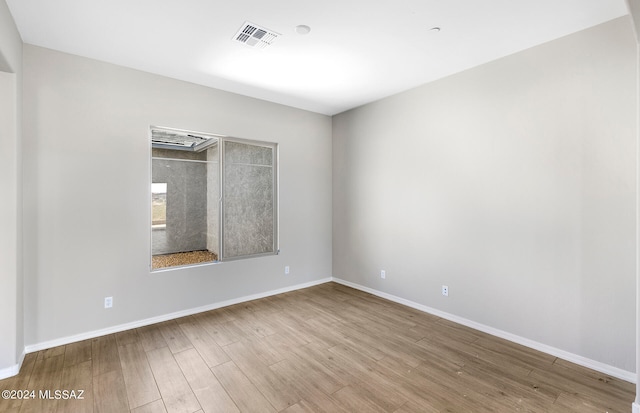 unfurnished room with light hardwood / wood-style floors