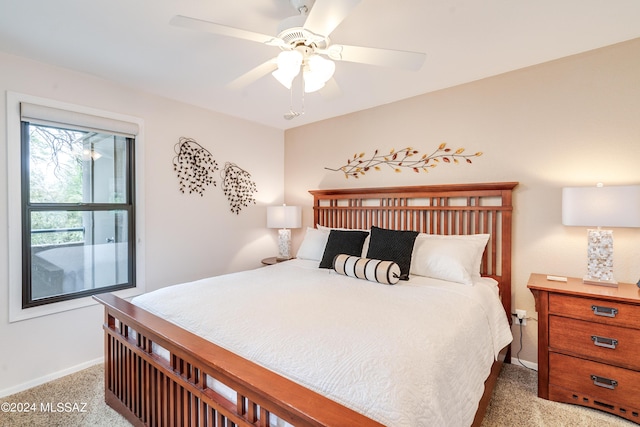 carpeted bedroom featuring ceiling fan and baseboards