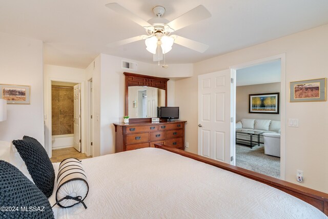 bedroom with ceiling fan, visible vents, and connected bathroom