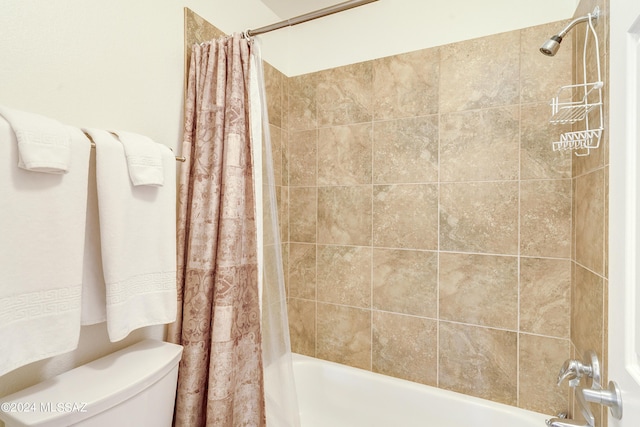 bathroom featuring shower / bath combination with curtain and toilet