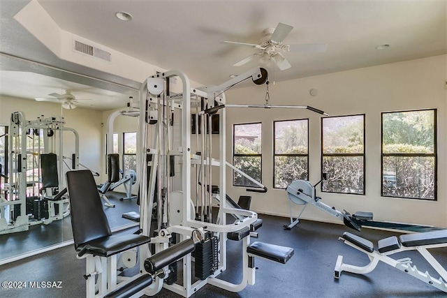 exercise room featuring baseboards, visible vents, and a ceiling fan