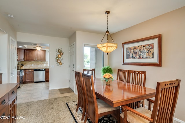 dining room with light tile patterned flooring, a ceiling fan, and baseboards