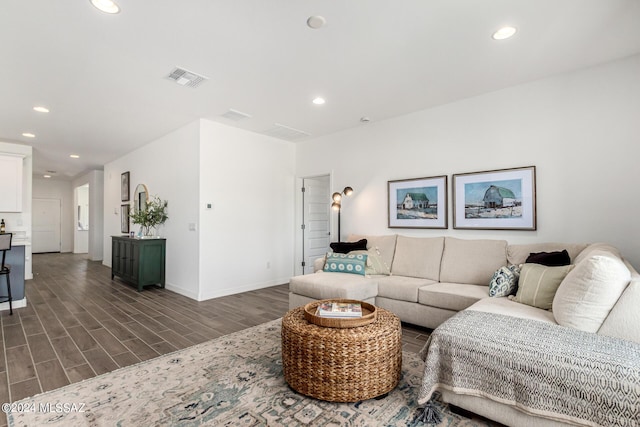 living area with recessed lighting, visible vents, and dark wood finished floors