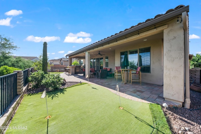 view of yard featuring ceiling fan and a patio area