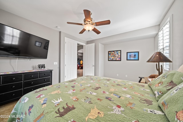 bedroom with ceiling fan and carpet floors