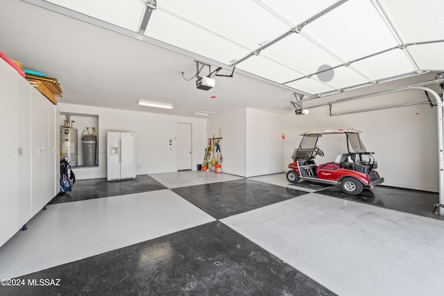 garage with gas water heater, white fridge with ice dispenser, and a garage door opener