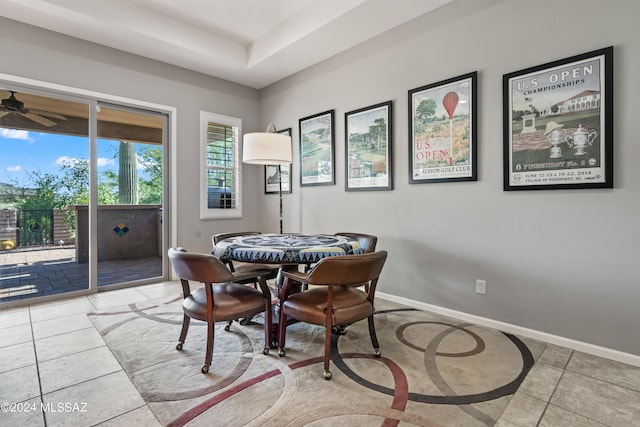 tiled dining space with ceiling fan