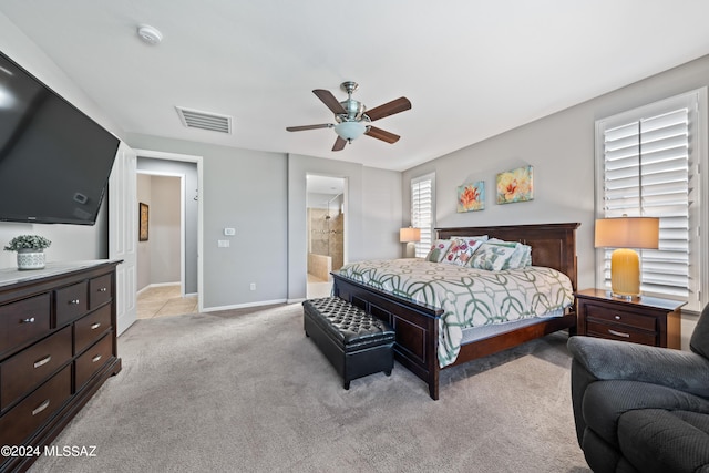 carpeted bedroom with ceiling fan and connected bathroom