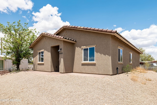 6860 W Walking M, Tucson, AZ 85757 - rear view of property with a tile roof, fence, a patio, and stucco siding