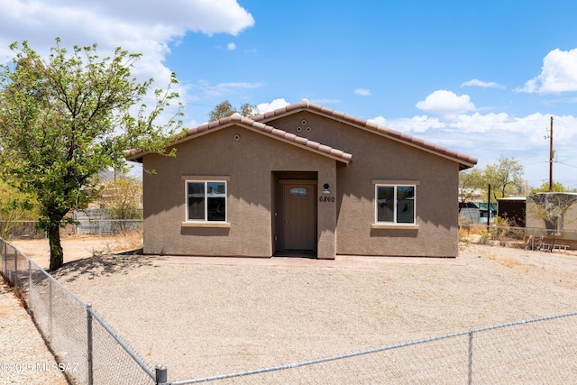6860 W Walking M, Tucson, AZ 85757 - view of front facade with a tiled roof, stucco siding, and a fenced backyard