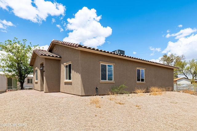 6860 W Walking M, Tucson, AZ 85757 - view of home's exterior with fence, stucco siding, and a tiled roof