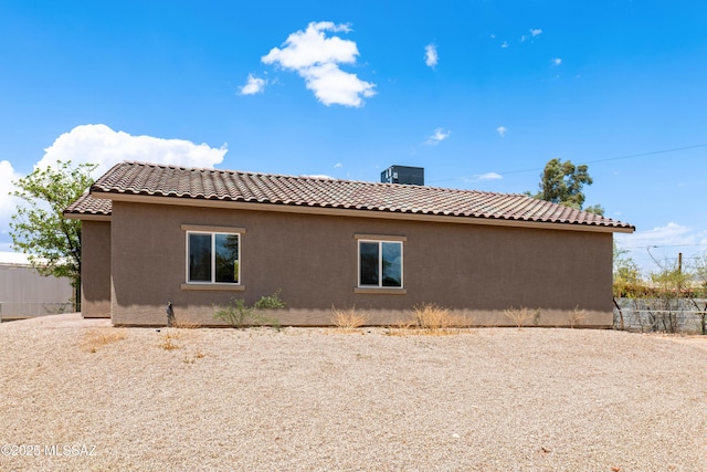 6860 W Walking M, Tucson, AZ 85757 - view of side of property with a tiled roof, stucco siding, and fence